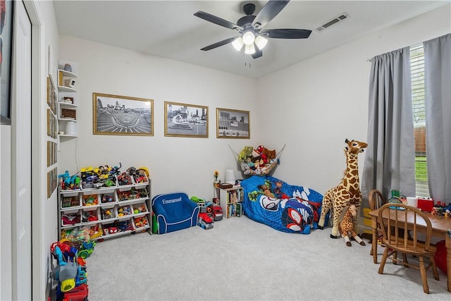 rec room with ceiling fan, carpet flooring, and visible vents