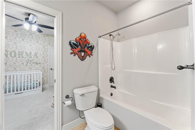full bathroom with ceiling fan, tub / shower combination, toilet, wallpapered walls, and baseboards