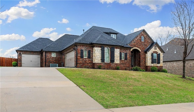 french country inspired facade featuring fence, a front lawn, brick siding, an attached garage, and driveway