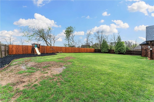 view of yard featuring a fenced backyard and a playground