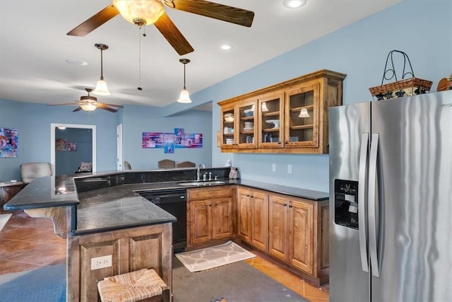 1402 NE Fairwinds Dr, Bentonville, AR 72712 - kitchen with brown cabinetry, a peninsula, a ceiling fan, dishwasher, and stainless steel fridge