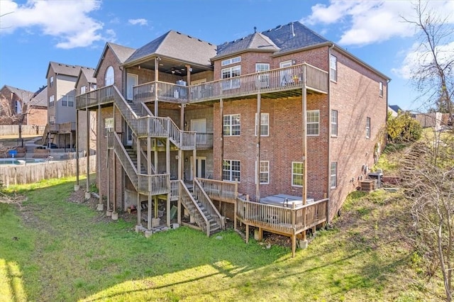 1402 NE Fairwinds Dr, Bentonville, AR 72712 - rear view of property featuring a deck, a yard, stairway, fence, and brick siding
