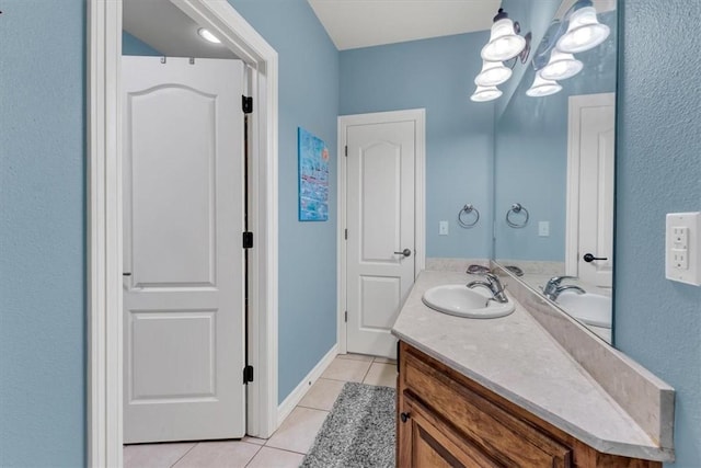 1402 NE Fairwinds Dr, Bentonville, AR 72712 - bathroom with tile patterned floors, vanity, and an inviting chandelier