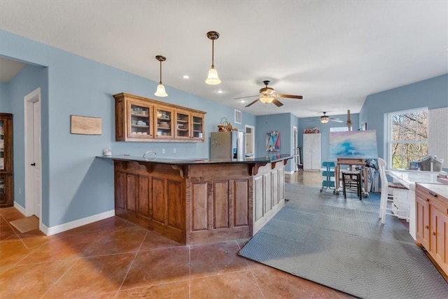 1402 NE Fairwinds Dr, Bentonville, AR 72712 - bar featuring a ceiling fan, tile patterned flooring, stainless steel fridge, hanging light fixtures, and baseboards