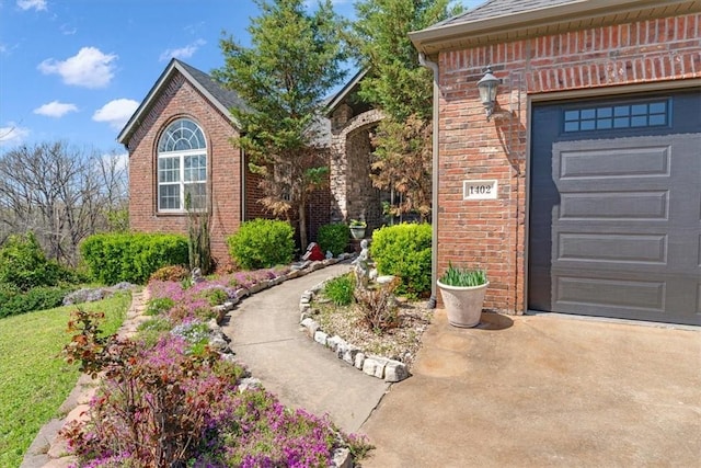 1402 NE Fairwinds Dr, Bentonville, AR 72712 - property entrance featuring concrete driveway and brick siding