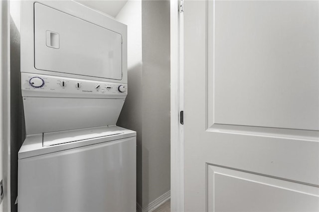 washroom with stacked washer / dryer and laundry area