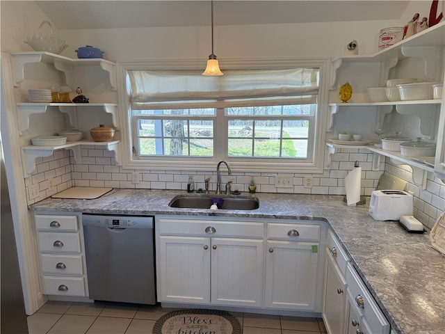 kitchen featuring dishwasher, light tile patterned flooring, open shelves, and a sink
