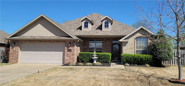 view of front of property with driveway, an attached garage, a front yard, brick siding, and a shingled roof