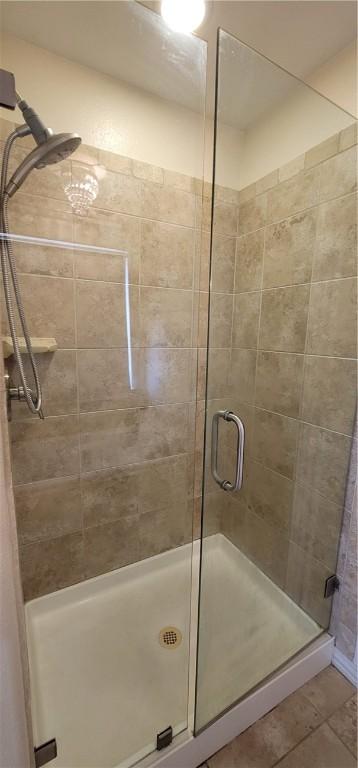 full bathroom featuring tile patterned floors and a stall shower