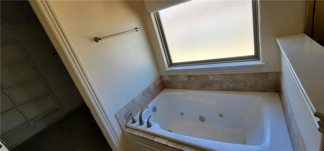 bathroom featuring a tub with jets