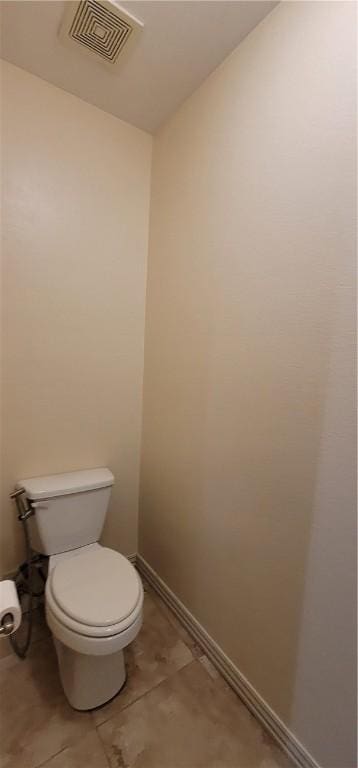 bathroom with toilet, tile patterned floors, baseboards, and visible vents
