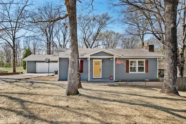 1 Bedford Ln, Bella Vista, AR 72714 - ranch-style home with an outdoor structure, a front lawn, an attached garage, a chimney, and driveway