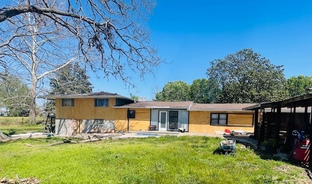 rear view of house with a yard
