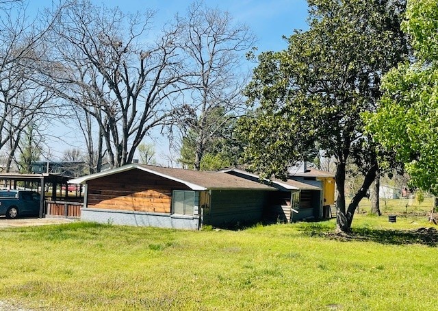 view of side of home with a yard