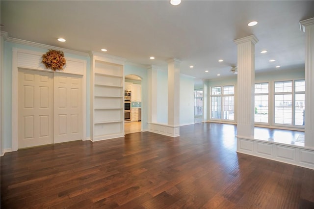 unfurnished living room featuring ornamental molding, decorative columns, recessed lighting, and dark wood finished floors