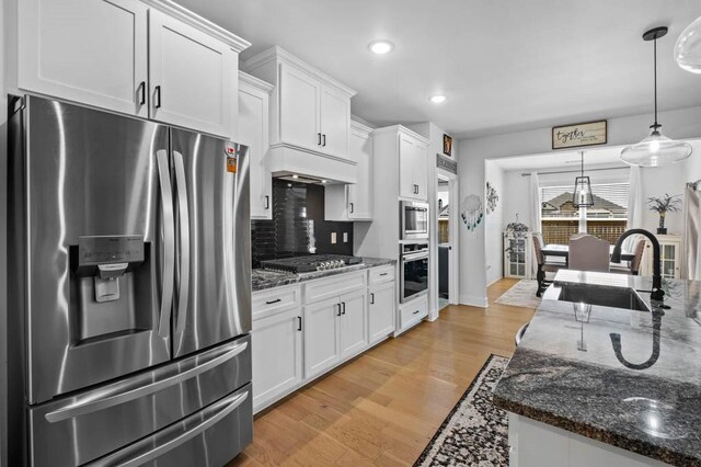 1241 Silver Maple St, Centerton, AR 72719 - kitchen with stainless steel appliances, a sink, white cabinets, decorative backsplash, and recessed lighting