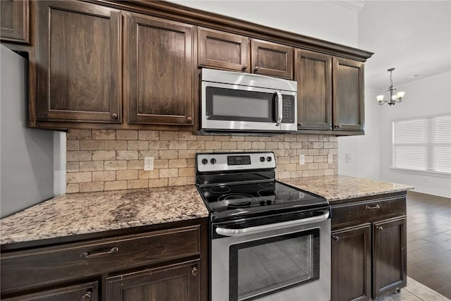 kitchen featuring dark brown cabinets, decorative backsplash, and appliances with stainless steel finishes