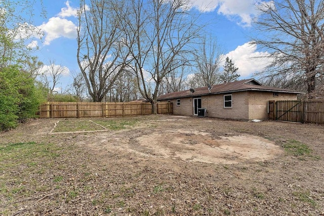 view of yard with central AC unit and fence private yard