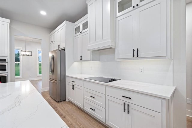 17153 Mill Hill Rd, Garfield, AR 72732 - kitchen with appliances with stainless steel finishes, light wood-type flooring, light stone counters, glass insert cabinets, and white cabinetry