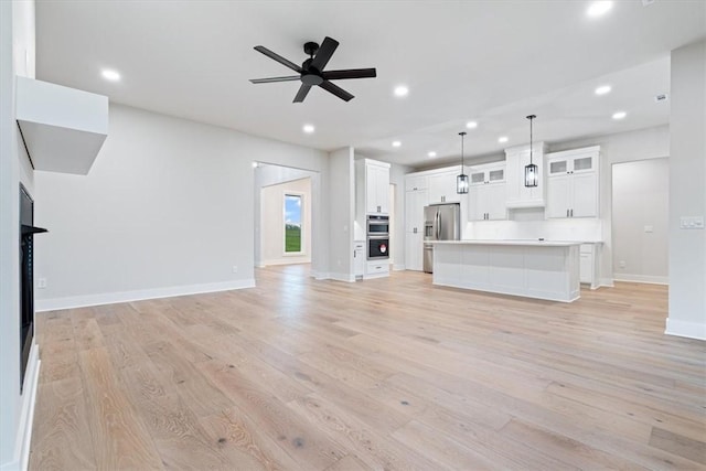 17153 Mill Hill Rd, Garfield, AR 72732 - unfurnished living room featuring recessed lighting, light wood-style flooring, ceiling fan, and baseboards