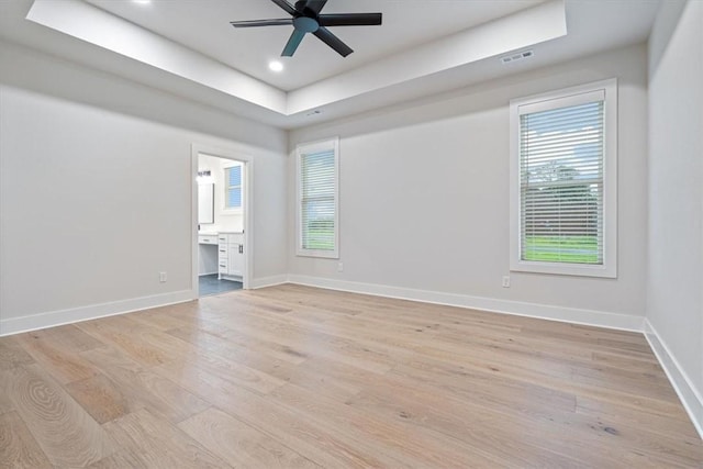 17153 Mill Hill Rd, Garfield, AR 72732 - unfurnished room with light wood-type flooring, a ceiling fan, a tray ceiling, and a healthy amount of sunlight