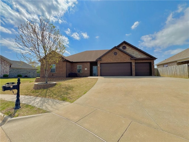 ranch-style house featuring driveway, an attached garage, fence, a front yard, and brick siding