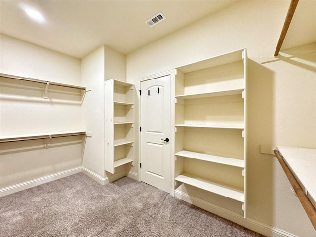 walk in closet featuring carpet floors and visible vents