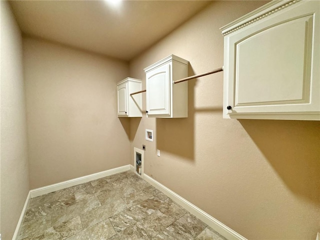 clothes washing area featuring stone finish floor, baseboards, electric dryer hookup, cabinet space, and washer hookup