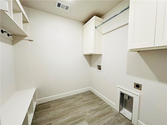 6405 NW Harley St, Bentonville, AR 72713 - washroom with hookup for an electric dryer, cabinet space, light wood-style flooring, and washer hookup