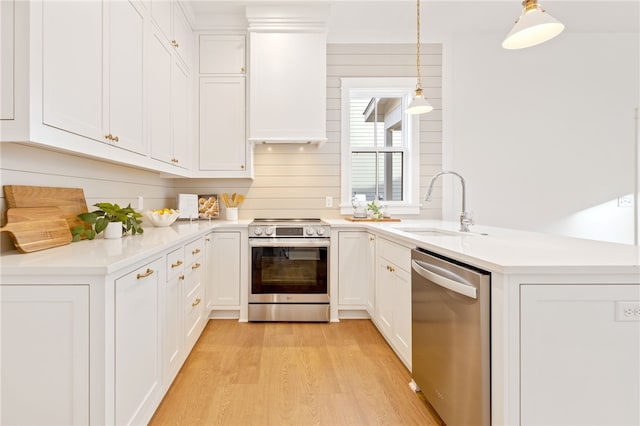 kitchen with a peninsula, light countertops, and stainless steel appliances