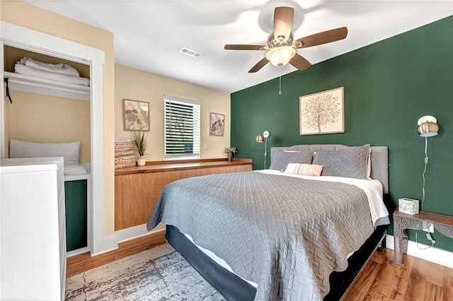 10093 Oklahoma Dr, Rogers, AR 72758 - bedroom featuring visible vents, a ceiling fan, and wood finished floors