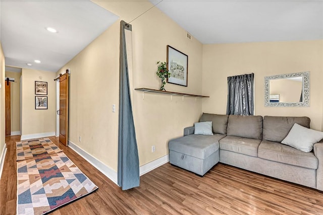 10093 Oklahoma Dr, Rogers, AR 72758 - living room with baseboards, recessed lighting, a barn door, visible vents, and wood finished floors