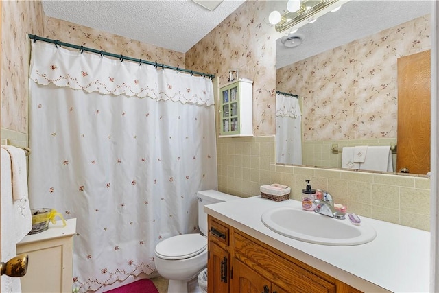 304 Angela St, Springdale, AR 72762 - full bathroom featuring toilet, tile walls, a textured ceiling, vanity, and wallpapered walls