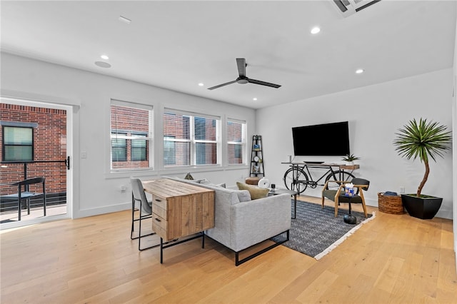 living area with visible vents, baseboards, ceiling fan, light wood-style floors, and recessed lighting