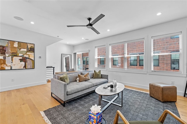 living room featuring ceiling fan, light wood-type flooring, and recessed lighting