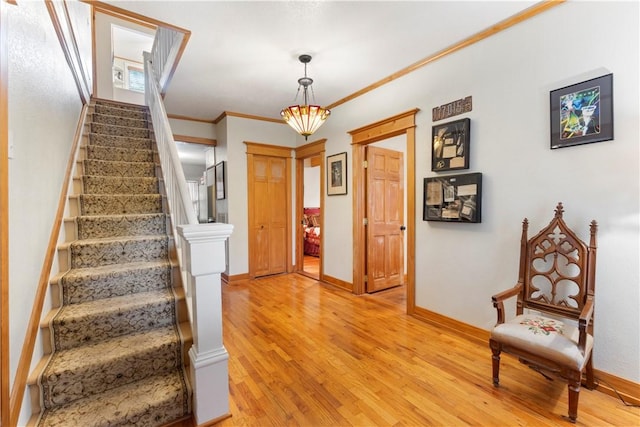 42 Vaughn St, Eureka Springs, AR 72632 - entryway featuring stairs, light wood finished floors, baseboards, and crown molding