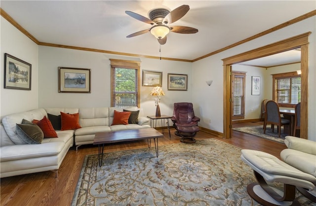 42 Vaughn St, Eureka Springs, AR 72632 - living area featuring healthy amount of natural light, wood finished floors, a ceiling fan, ornamental molding, and baseboards