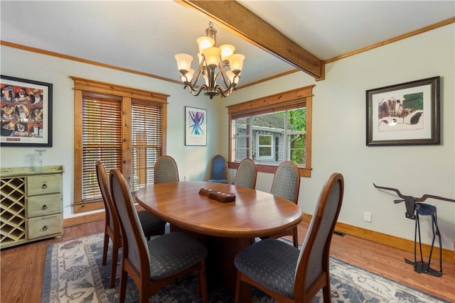 42 Vaughn St, Eureka Springs, AR 72632 - dining area with wood finished floors, baseboards, a chandelier, beamed ceiling, and crown molding
