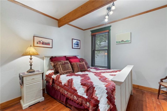 42 Vaughn St, Eureka Springs, AR 72632 - bedroom featuring ornamental molding, baseboards, beam ceiling, and hardwood / wood-style flooring