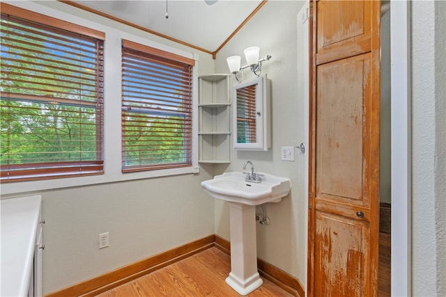 42 Vaughn St, Eureka Springs, AR 72632 - bathroom featuring vaulted ceiling, wood finished floors, baseboards, and a sink