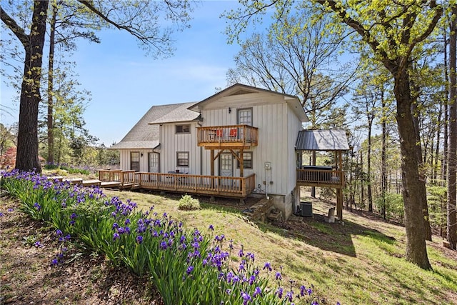 rear view of property with central AC, a wooden deck, and a balcony