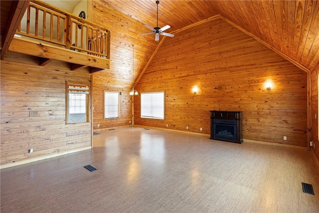 unfurnished living room with wooden ceiling, wood walls, a fireplace, and visible vents
