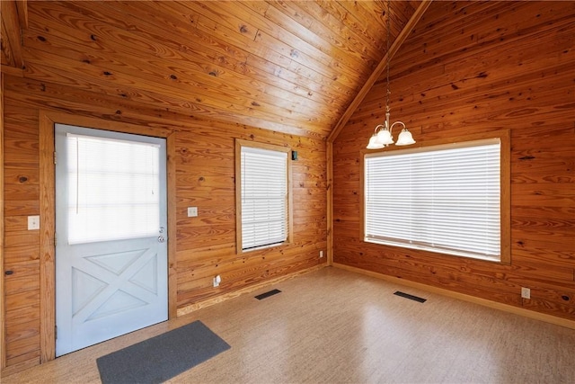 foyer featuring a chandelier, wood walls, visible vents, lofted ceiling, and wood ceiling