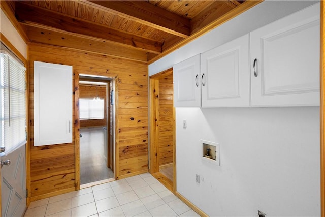 washroom with wooden walls, light tile patterned floors, washer hookup, cabinet space, and wood ceiling