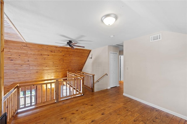 bonus room featuring ceiling fan, vaulted ceiling, visible vents, and hardwood / wood-style flooring