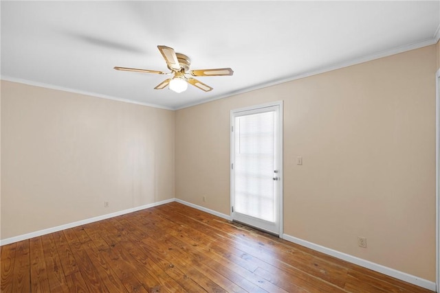unfurnished room with crown molding, ceiling fan, wood-type flooring, and baseboards