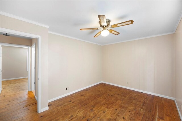 spare room with baseboards, a ceiling fan, and hardwood / wood-style flooring