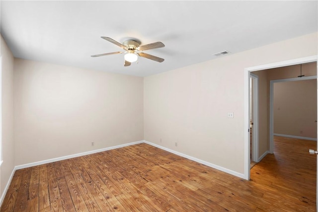 unfurnished room featuring visible vents, ceiling fan, light wood-style floors, and baseboards