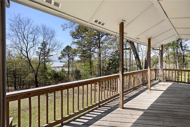 wooden terrace featuring visible vents