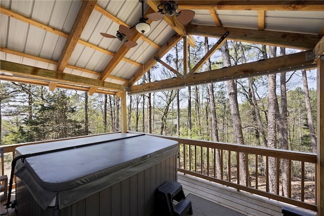 wooden deck with ceiling fan and a hot tub